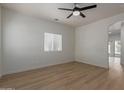 Spacious, light-filled bedroom featuring wood-look floors and a modern ceiling fan at 5635 S 11Th Dr, Phoenix, AZ 85041