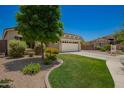 Beautiful home with well-manicured lawn, mature tree, and inviting curb appeal at 5735 S Cloverdale Ln, Gilbert, AZ 85298