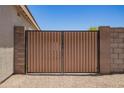 Modern fence with black hardware and brown metal panels at 5735 S Cloverdale Ln, Gilbert, AZ 85298