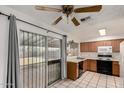 Functional kitchen with tile floors, classic cabinetry, and a sliding door to the backyard at 635 W Flower Ave, Mesa, AZ 85210