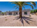 Charming single-story home featuring a two-car garage and desert-style landscaping for easy maintenance at 6944 E Gary Cir, Mesa, AZ 85207