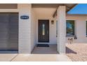 Close up showing the front door and a 2-car garage at 6944 E Gary Cir, Mesa, AZ 85207