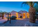 Inviting single-story home with desert landscaping and a lit front entrance, highlighted at twilight at 8158 E Rita Dr, Scottsdale, AZ 85255