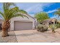 Single-story home features stucco, desert landscaping, and a spacious garage, set against a bright blue sky at 8158 E Rita Dr, Scottsdale, AZ 85255