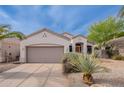Single-story home with desert landscaping and a spacious garage is displayed under a sunny, blue sky at 8158 E Rita Dr, Scottsdale, AZ 85255