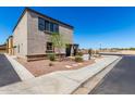 View of the home's exterior with desert landscaping and a sidewalk at 8208 W Albeniz Pl, Phoenix, AZ 85043