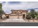 Charming two-story home features a three-car garage, desert landscaping, and a tile roof at 8766 W Hayward Ave, Glendale, AZ 85305