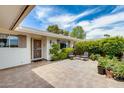 Inviting front porch with tiled flooring, seating area, and manicured landscaping at 10137 W Forrester Dr, Sun City, AZ 85351