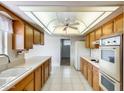 Well-lit kitchen featuring wood cabinets, white countertops, and ample storage space at 10137 W Forrester Dr, Sun City, AZ 85351