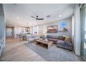 An open-concept living room seamlessly connects to dining, creating an inviting space with ample natural light at 12239 W Caraveo Pl, Peoria, AZ 85383