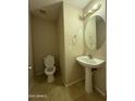 Half bath includes a pedestal sink, and tiled floors at 12547 W Pasadena Ave, Litchfield Park, AZ 85340