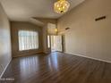 Open-concept living room with wood floors, vaulted ceilings, and natural light, offering a welcoming atmosphere at 12547 W Pasadena Ave, Litchfield Park, AZ 85340