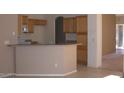 Kitchen area with tile flooring, breakfast bar, wood cabinetry and stainless steel appliances at 1412 E Oakland St, Gilbert, AZ 85295