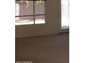 Neutral carpeted living room with large windows and glass door at 1412 E Oakland St, Gilbert, AZ 85295
