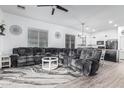 Spacious living room boasts lots of natural light, wood floors, a ceiling fan, and an open floor plan at 15515 N 165Th Ave, Surprise, AZ 85388