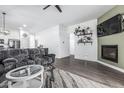 Bright living room showcases wood floors, fireplace, and seamless transitions into the kitchen and dining areas at 15515 N 165Th Ave, Surprise, AZ 85388