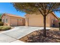Desert home with a spacious driveway leading to a two-car garage and additional parking at 16860 W Soft Wind Dr, Surprise, AZ 85387