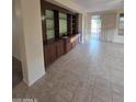 The living room features a custom built-in entertainment center and access to a patio via sliding glass doors at 22508 W Antelope Trl, Buckeye, AZ 85326
