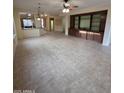Spacious living room with tile flooring, ceiling fan, recessed lighting, and a large built-in entertainment center at 22508 W Antelope Trl, Buckeye, AZ 85326