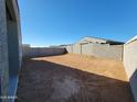 Expansive backyard enclosed by a concrete block wall ready for landscape design at 37153 W Prado St, Maricopa, AZ 85138