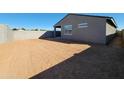 Large backyard of new home with cinder block fence and area prepared for landscaping at 37153 W Prado St, Maricopa, AZ 85138