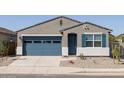 Inviting single-story home with a blue garage door and shutters, set against a grey stucco exterior with desert landscaping at 37153 W Prado St, Maricopa, AZ 85138