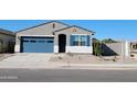 Charming single-story home featuring a blue garage door and decorative blue shutters at 37153 W Prado St, Maricopa, AZ 85138