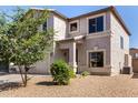 An angled view of the home reveals a beige stucco facade and tidy xeriscaped yard at 379 E Cheyenne Rd, San Tan Valley, AZ 85143