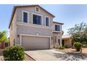 This beige stucco home showcases a two-car garage, xeriscaping, and neutral trim at 379 E Cheyenne Rd, San Tan Valley, AZ 85143