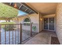 Inviting entrance with brick facade and decorative security door and block fence at 3833 W Phelps Rd, Phoenix, AZ 85053