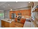 Open kitchen with stainless steel appliances, a center island, and windows that provide plenty of natural light at 3935 E Rough Rider Rd # 1360, Phoenix, AZ 85050