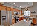 Modern kitchen featuring stainless steel appliances, wood cabinets, and a beautiful island with stone countertops at 3935 E Rough Rider Rd # 1360, Phoenix, AZ 85050
