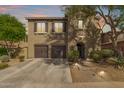 Attractive two-story home with tile roof, brown shutters, and arched front door under a shady tree at 3964 E Hummingbird Ln, Phoenix, AZ 85050