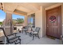 Inviting front porch with comfortable seating and decorative wreath on the front door at 4553 W Kirkland Ave, San Tan Valley, AZ 85144