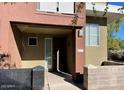 Townhouse featuring a covered front porch and stone accents, enhancing curb appeal at 6605 N 93Rd Ave # 1071, Glendale, AZ 85305