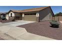 Well maintained single story home featuring desert landscaping, two car garage, and private entryway at 6713 S 76Th Dr, Laveen, AZ 85339
