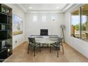 The office boasts carpeted floors, three front-facing windows, recessed lighting, and custom shelving at 7180 W Tombstone Trl, Peoria, AZ 85383