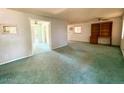 Spacious living room features neutral walls, wall unit and doorway leading to the back at 735 E Desert Ave, Apache Junction, AZ 85119