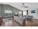 Stylish living room showcasing high ceilings, wood floors, and two comfortable sofas at 7405 W Elwood St, Phoenix, AZ 85043