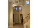 Open foyer showcasing a staircase, chandelier, and unique architectural details at 7422 W Superior Ave, Phoenix, AZ 85043