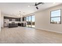 Bright open-concept living space featuring tile floors, a modern kitchen, and access to a large backyard at 802 W Buist Ave, Phoenix, AZ 85041