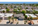 Expansive aerial view of a residential community with tree-lined streets and diverse home styles at 9339 E Sun Lakes N Blvd, Sun Lakes, AZ 85248