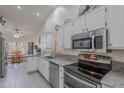 Well-lit kitchen featuring white cabinetry, stainless steel appliances, and granite countertops at 9339 E Sun Lakes N Blvd, Sun Lakes, AZ 85248