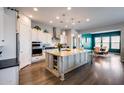 Modern kitchen featuring a large center island, stainless steel appliances, pendant lights and eat-in breakfast nook at 9723 W Patrick Ln, Peoria, AZ 85383