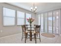 Bright dining area features a modern chandelier, and lots of natural light at 10739 W Sierra Pinta Dr, Peoria, AZ 85373
