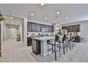 Spacious kitchen features an island with bar seating, stainless appliances, and ample storage space at 10739 W Sierra Pinta Dr, Peoria, AZ 85373