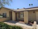 Covered front porch with decorative columns, shutters on windows, and desert landscaping at 12016 N 45Th Ave, Glendale, AZ 85304
