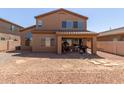 The backyard has a gravel-covered landscape, a covered patio, and a built-in BBQ grill at 14436 N 162Nd Ln, Surprise, AZ 85379