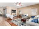 Bright living room features a ceiling fan and comfortable seating for entertaining guests at 14436 N 162Nd Ln, Surprise, AZ 85379