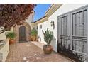 Private courtyard with beautiful potted plants and secure iron gates at 1535 W Winter Dr, Phoenix, AZ 85021